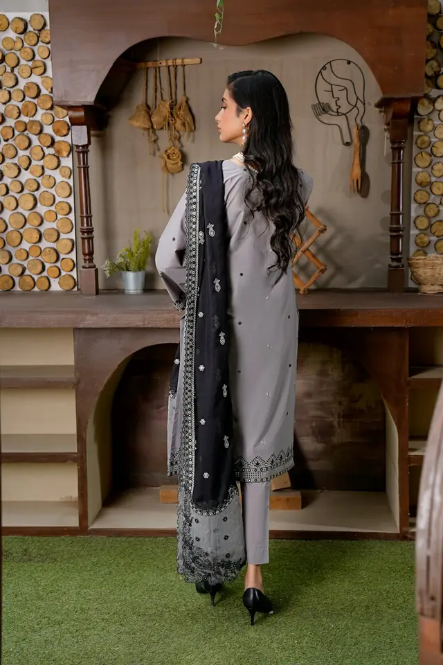 Woman wearing a grey outfit with a black embroidered dupatta