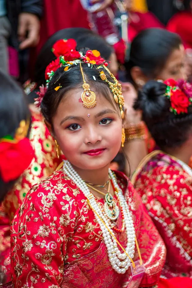 Young girl in a red and gold traditional dress