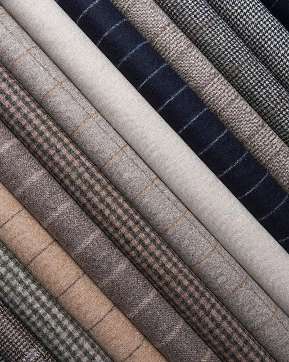 Suiting fabrics in checks, stripes and herringbone laid side by side