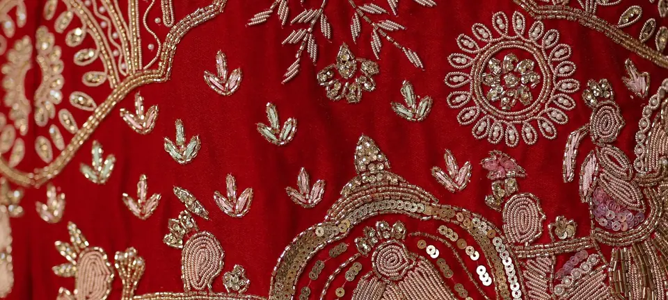 Close-up of red silk with gold zari embroidery